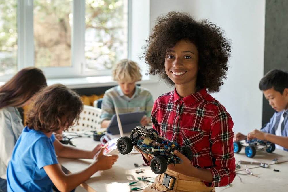 Happy,African,American,Junior,School,Kid,Holding,Robotic,Car,Looking